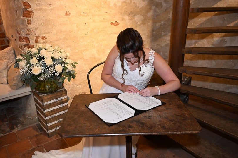 Wedding ceremony signing bride