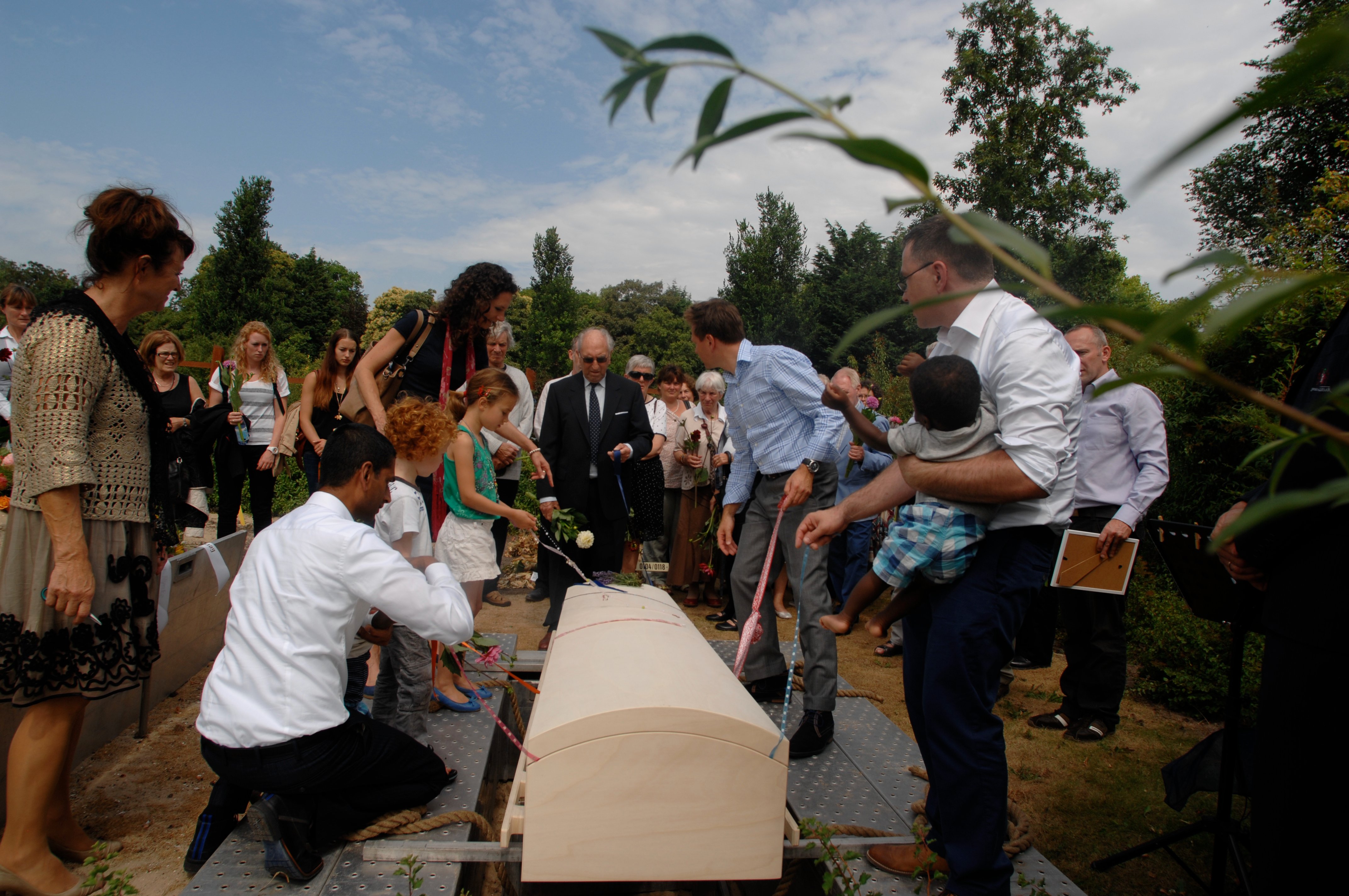 Lowering the coffin in grave